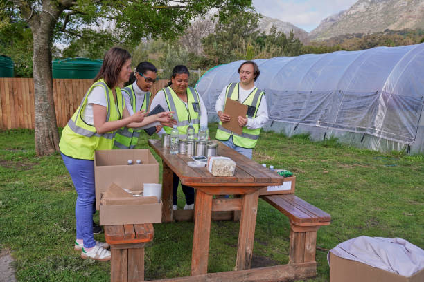 istock Group of volunteers packaging donation boxes at table outdoors 2194003534
