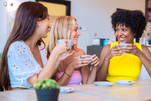 istock Three Women Enjoying Coffee and Laughing in a Cozy Cafe 2194004974