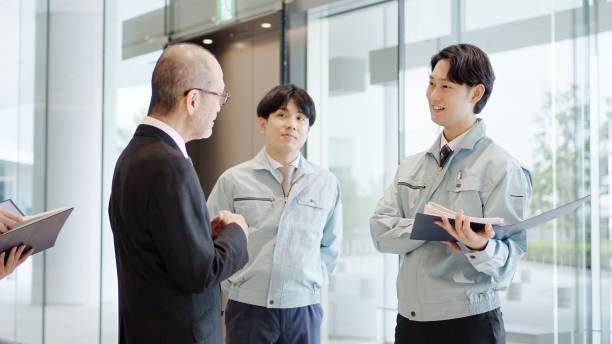 istock A businessman and a man in work clothes talking in the lobby 2194005575