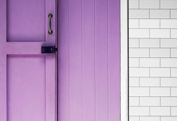 Architectural background with purple wooden door and grey tile texture background