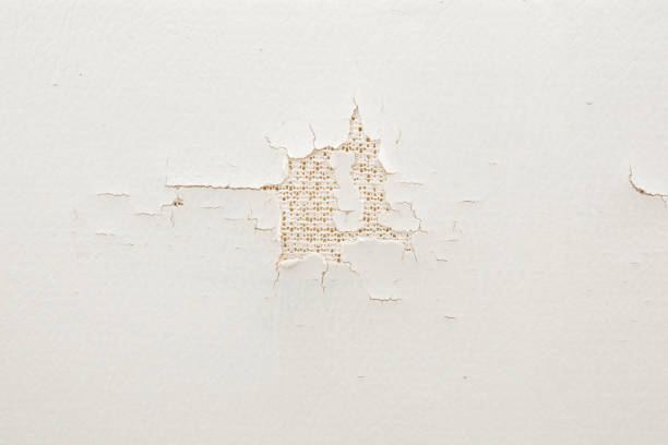 Cracked damaged old white leather seat background. Closeup. Top down view.