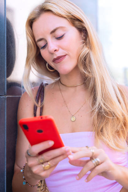 istock Blonde Woman Using Smartphone Outdoors in Urban Setting.Vertical 2194009611