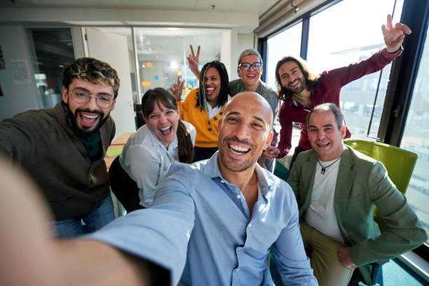 istock Happy business team taking a selfie in modern office together. 2194010961