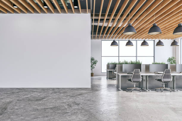 istock A modern office interior with white wall and copy space,  a wooden slats ceiling, work desks and large windows, on concrete floor 2194011691
