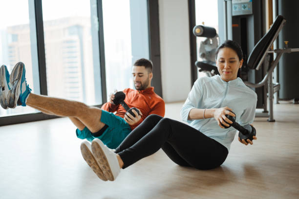 Couple working out together in the gym room. stock photo
