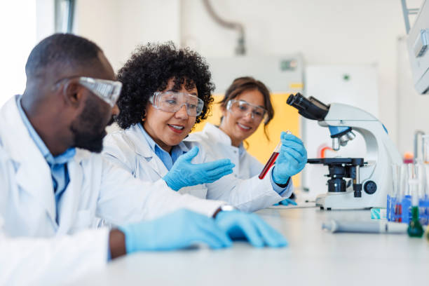 istock Scientists examining test tube with red liquid in laboratory 2194013103