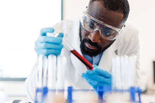 istock Scientist analyzing a red liquid in test tube in laboratory 2194013125