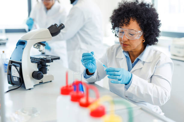 istock Scientist dropping liquid with pipette in laboratory glassware 2194013220