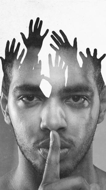istock Conceptual art design. Man with serious expression, finger on lips, layered with hands, symbolizing silenced voices. Black and white, textured effects. 2194013375