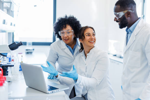 istock Scientists having a meeting in laboratory looking at laptop 2194013424