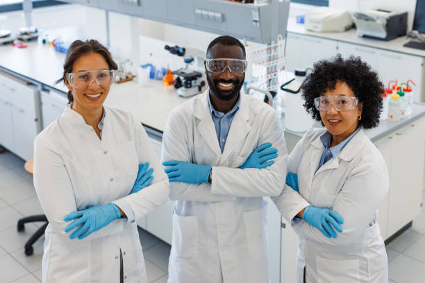 istock Multi-ethnic team of scientists smiling at camera in laboratory 2194013512