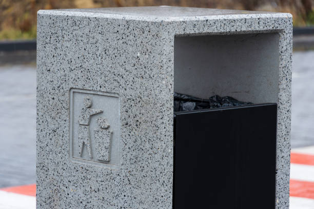 istock A concrete trash bin stands prominently, promoting proper waste management and recycling in an urban area, demonstrating environmental care 2194013896