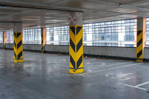 istock Spacious parking garage with designated spots and safety markers, providing secure vehicle storage in a contemporary urban environment 2194013956