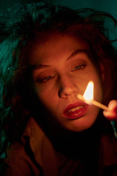 istock Woman Looking at Burning Match 2194013993