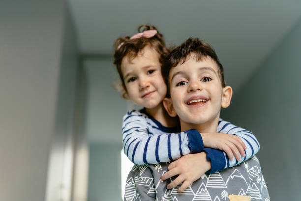 istock Brother And Sister Sharing Affectionate Moment At Home With Smiles 2194014441