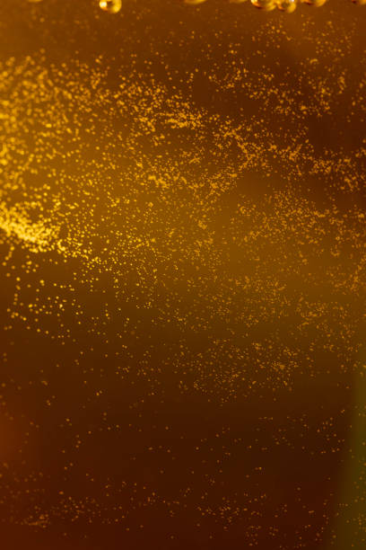 pour apple juice into a glass, apple juice in a clear glass with bubbles