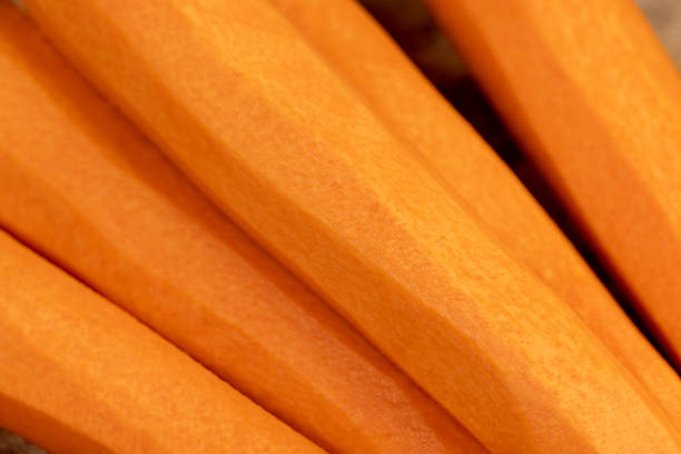 peeled orange carrots on the table during cooking, sweet ripe orange carrots peeled and washed for cooking