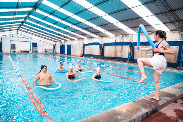 istock Teacher and students on hydrotherapy on a swimming pool 2194020791