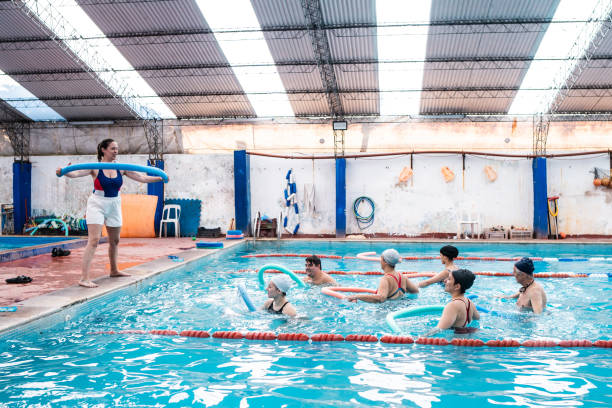 istock Teacher and students on hydrotherapy on a swimming pool 2194020816