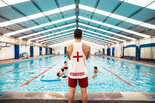 Rear view of a lifeguard on a swimming pool