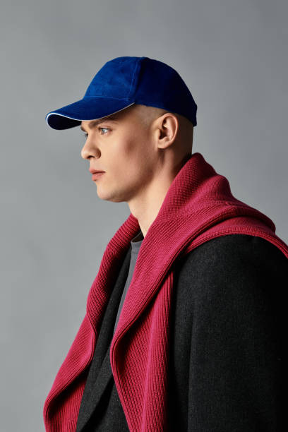 istock Young man in stylish attire with vibrant accessories in a minimalist studio setting 2194020957