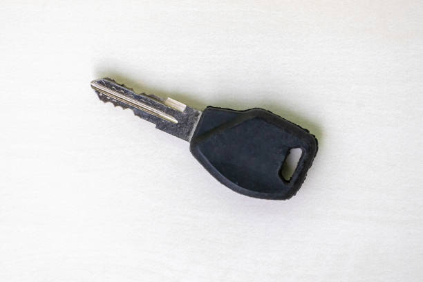details of key ring with various door and car keys against a white background,