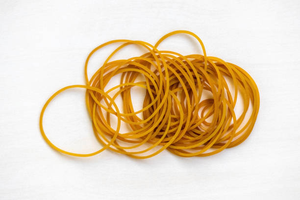 istock Many rubber bands, isolated on a white background. Thick, elastic bands for stationary, office supplies, travel, home items, fixing, and organizing. 2194022199