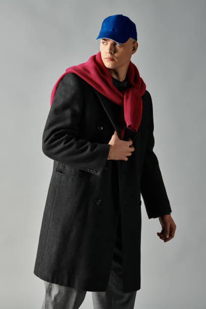 istock Stylish young man poses confidently in a modern studio with creative lighting 2194022356