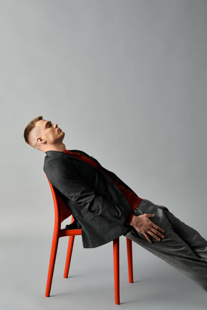 istock Young man relaxed in modern chair exuding cool confidence in stylish setting 2194022650