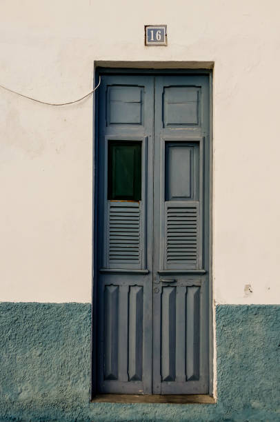 istock A blue door with a window and a number 16 on it 2194023008