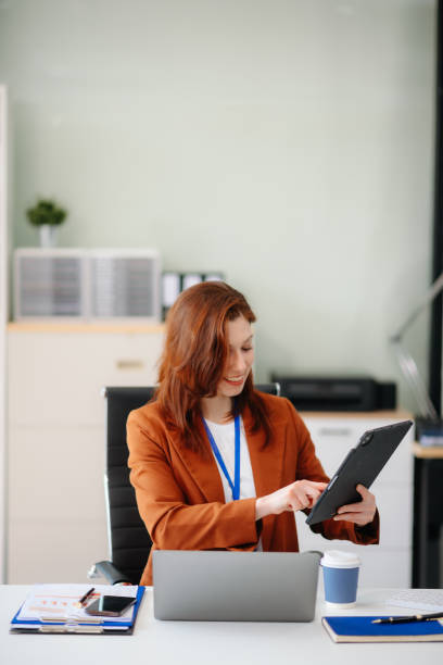 istock businesswoman working with working notepad, tablet and laptop documents talking on the smartphone, tablet 2194023588