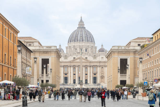 Vatican City, Rome - Nov 14th, 2024: A bustling crowd walks along the Via della Conciliazione, leading to St. Peter's Basilica