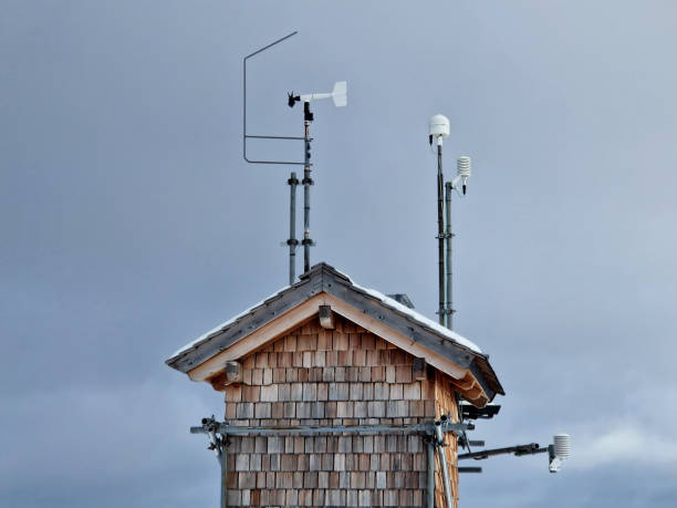 shingle cladding of a mountain hut serving as alpine weather station. metal construction, equipped with expensive technology such as anemometer, thermometer, psychrometer, barometer with solar panel