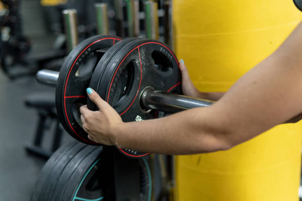 istock Close up view, woman's hands holding weights in the gym, training and workout concept 2194026739