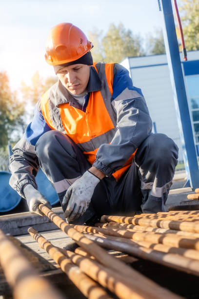 istock Caucasian male construction worker adjusting metal rods on site 2194028960