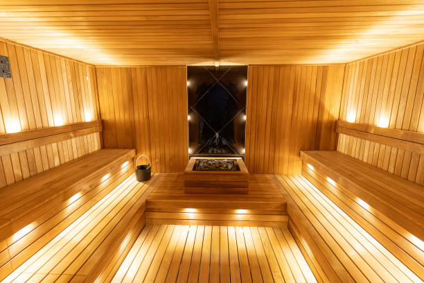 istock Modern Himalayan Salt Wall Sauna Interior with Warm Wooden Benches 2194032250