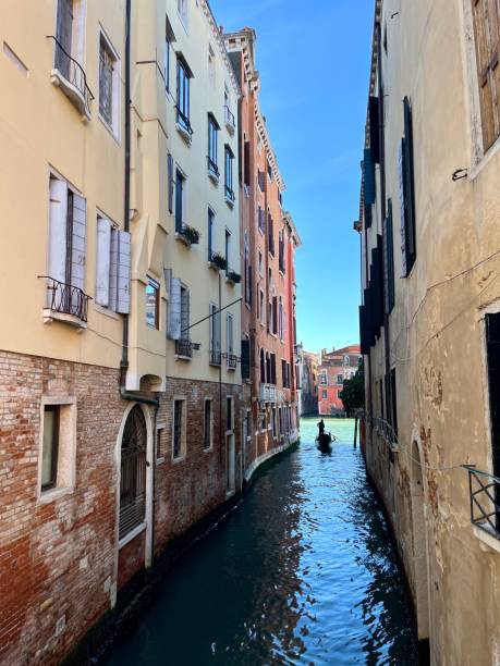 istock Gondolier navigating narrow canal in Venice, Italy 2194033281
