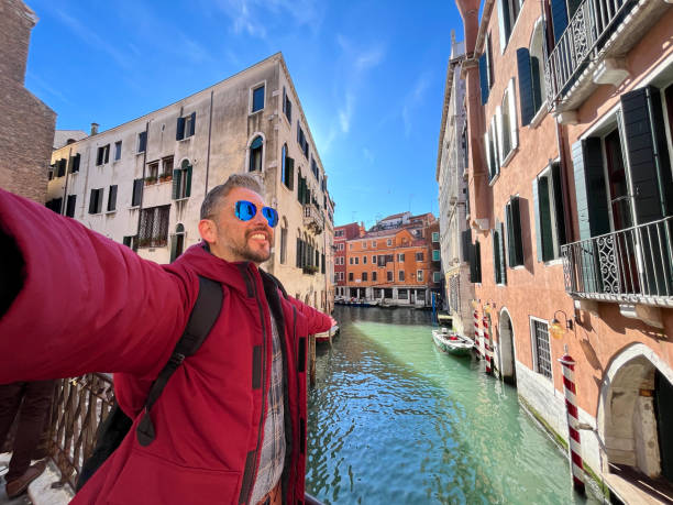 istock Tourist taking selfie with open arms in Venice, Italy 2194033285
