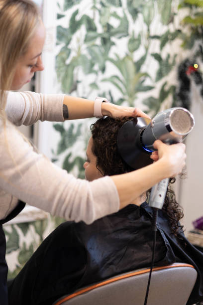 istock Salon session focusing on hair styling and drying techniques 2194037108