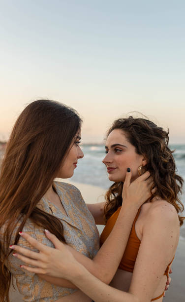 istock Lesbian couple embracing on beach 2194037300