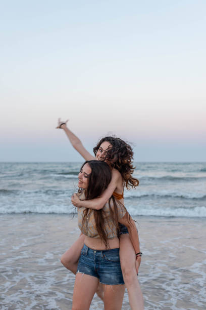 istock Lesbian couple having fun near sea 2194037356