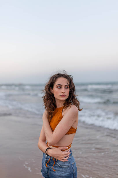 istock Young woman standing near sea 2194037395