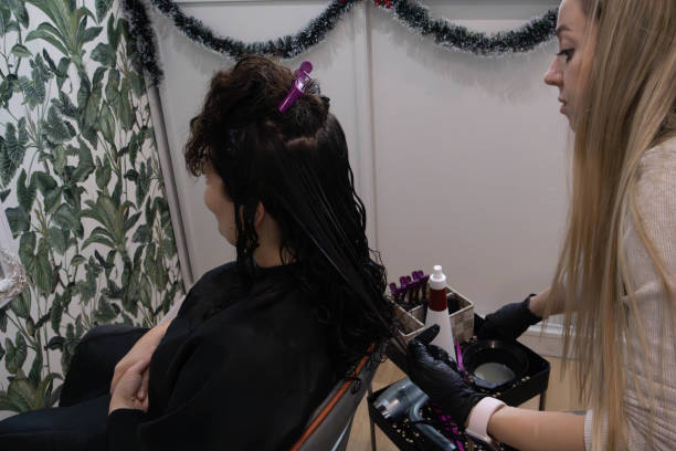 istock Expert hairstylist applying treatment to client in salon setting 2194037727