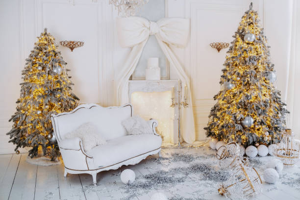 istock Festive winter setting with decorated Christmas trees and cozy sofa 2194037989