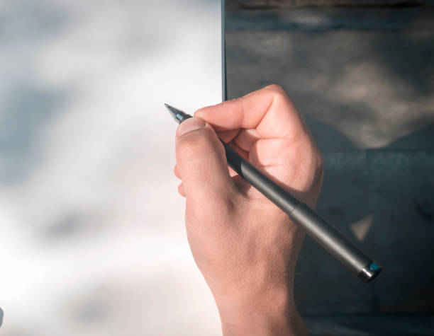 istock A man is doing notes, holding a notebook and a pen in his hands. 2194038463