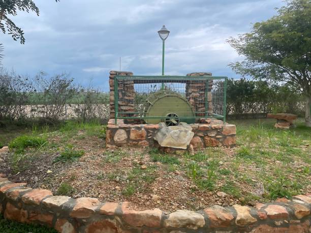istock Historic Watermill Display in Achna, Cyprus, Framed by Rustic Stonework and Natural Surroundings Under Overcast SkiesPreservation of Rural Heritage 2194039059