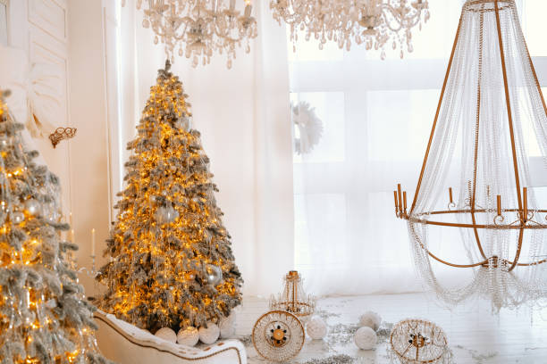 Cozy winter interior with a decorated Christmas tree and elegant chandelier