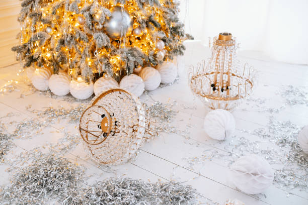 Winter decor with a Christmas tree and gold accents for 2025