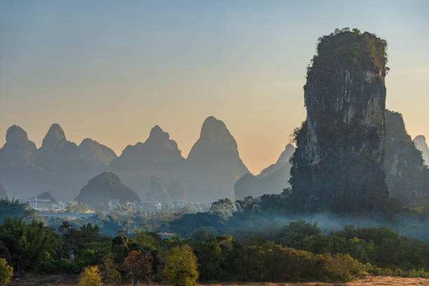 istock Vibrant Sunrise Over the Breathtakingly Beautiful Scenery and Dramatic Limestone Rock Formations of the Yulonghe Scenic Area of Yangshuo County, Guilin, GuangxiChina 2194040996