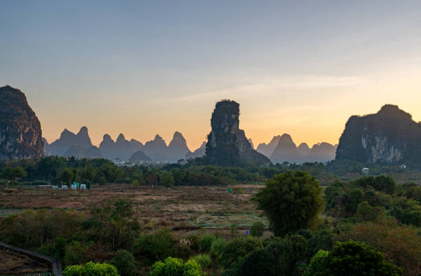 istock Vibrant Sunrise Over the Breathtakingly Beautiful Scenery and Dramatic Limestone Rock Formations of the Yulonghe Scenic Area of Yangshuo County, Guilin, GuangxiChina 2194041015